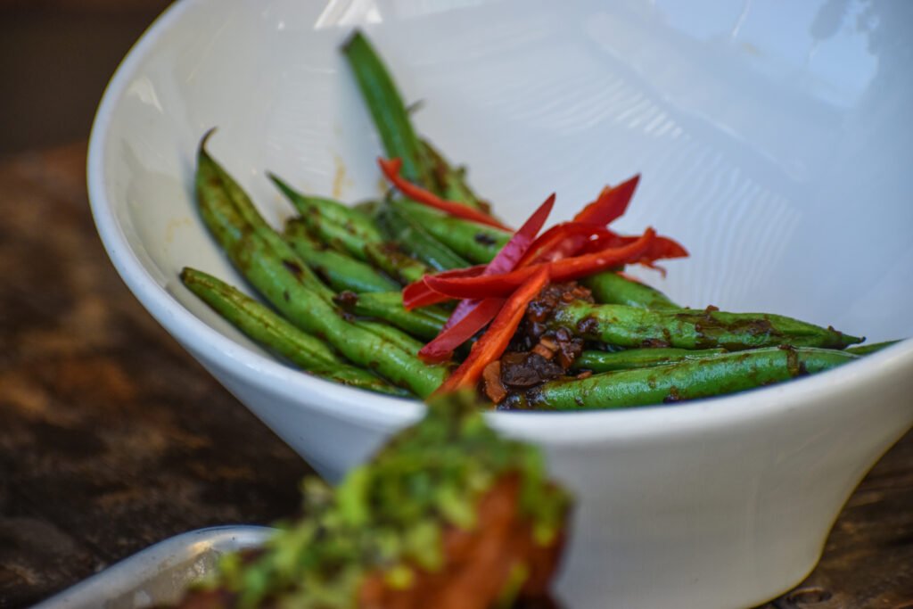 The fresh green beans with garlic, sesame, and Fresno chiles. Photo by Brian Addison.