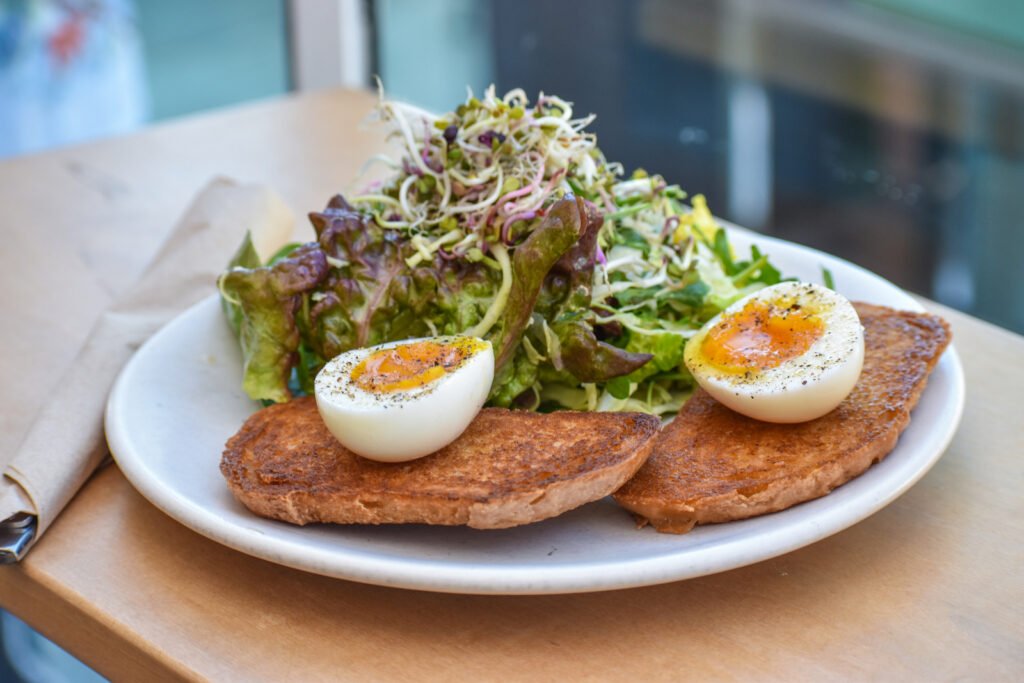 Simple but beautifully executed: A soft-boiled egg with toast and salad from Wide Eyes Open Palms. Photo by Brian Addison.