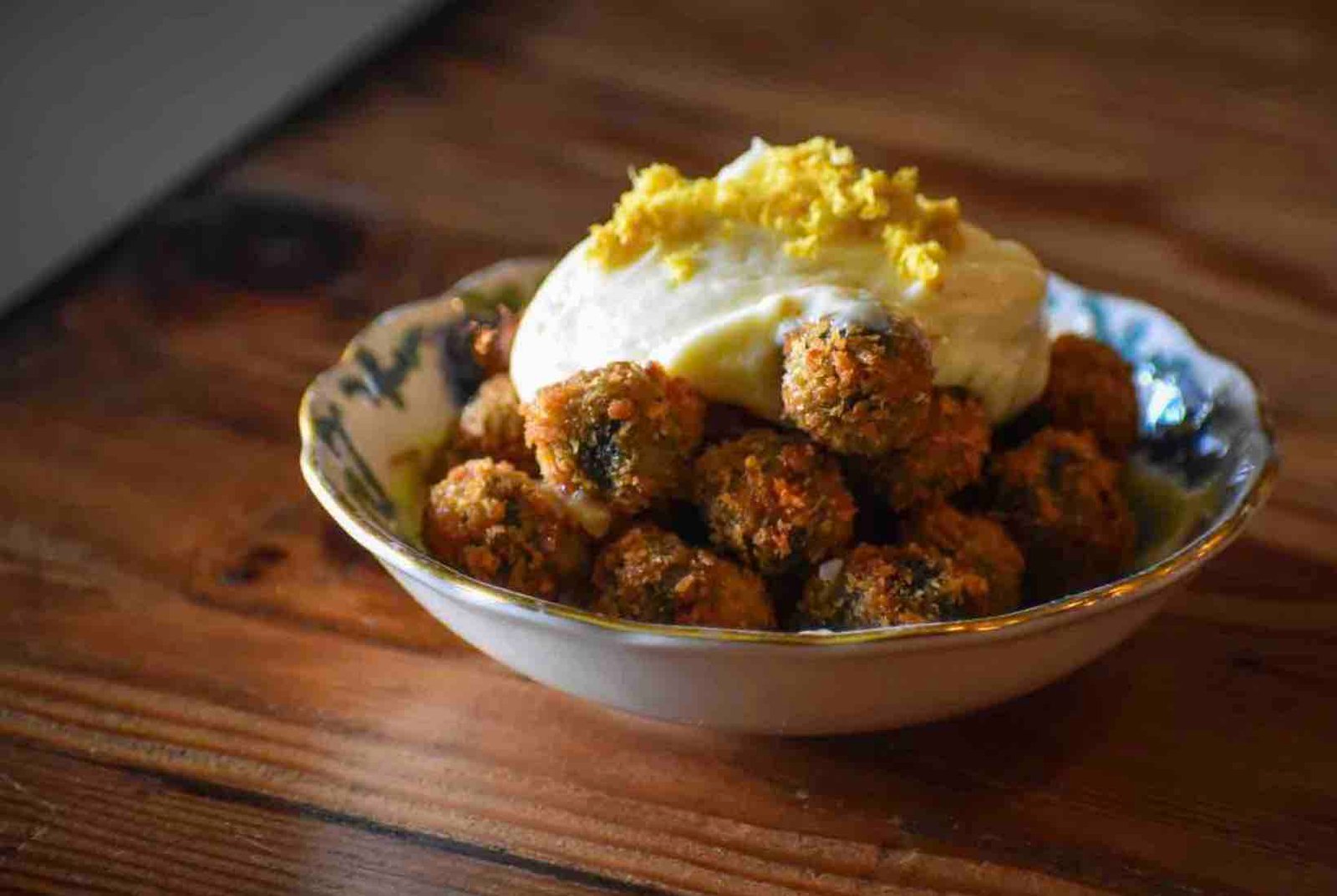 The fried olives, stuffed with n'duja salami and topped with lemon aioli from Wood & Salt. Photo by Brian Addison.