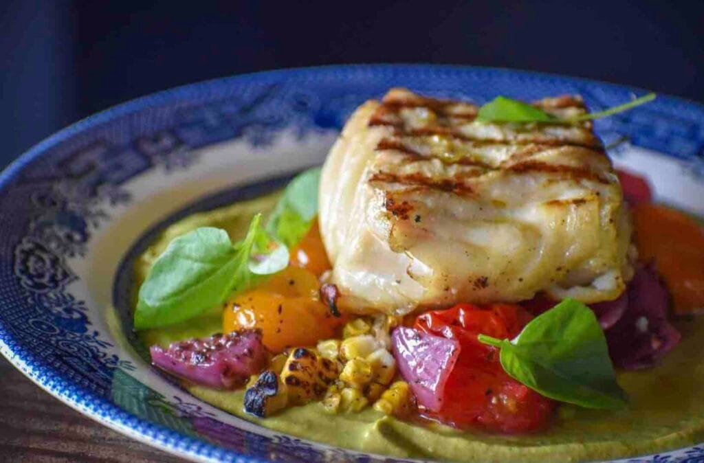 The grilled Alaskan halibut with zucchini puree and roasted corn and tomatoes from Wood & Salt. Photo by Brian Addison.