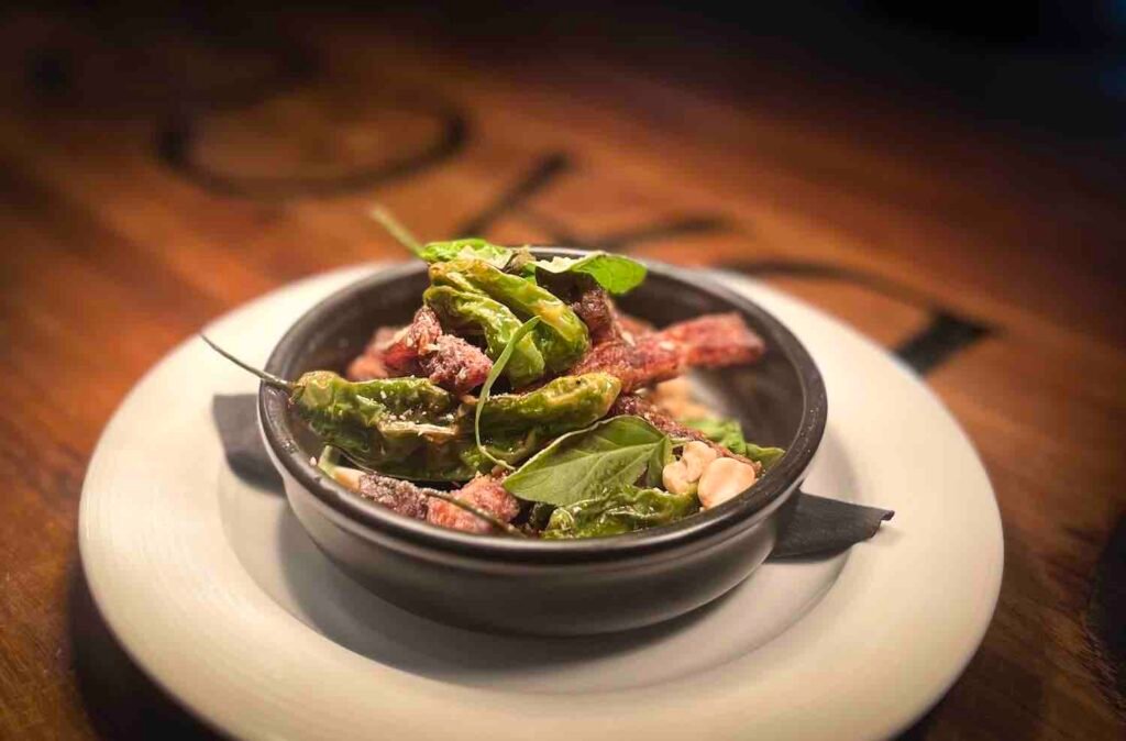 Crispy pig ear with shishito peppers. Photo by John Hansen.