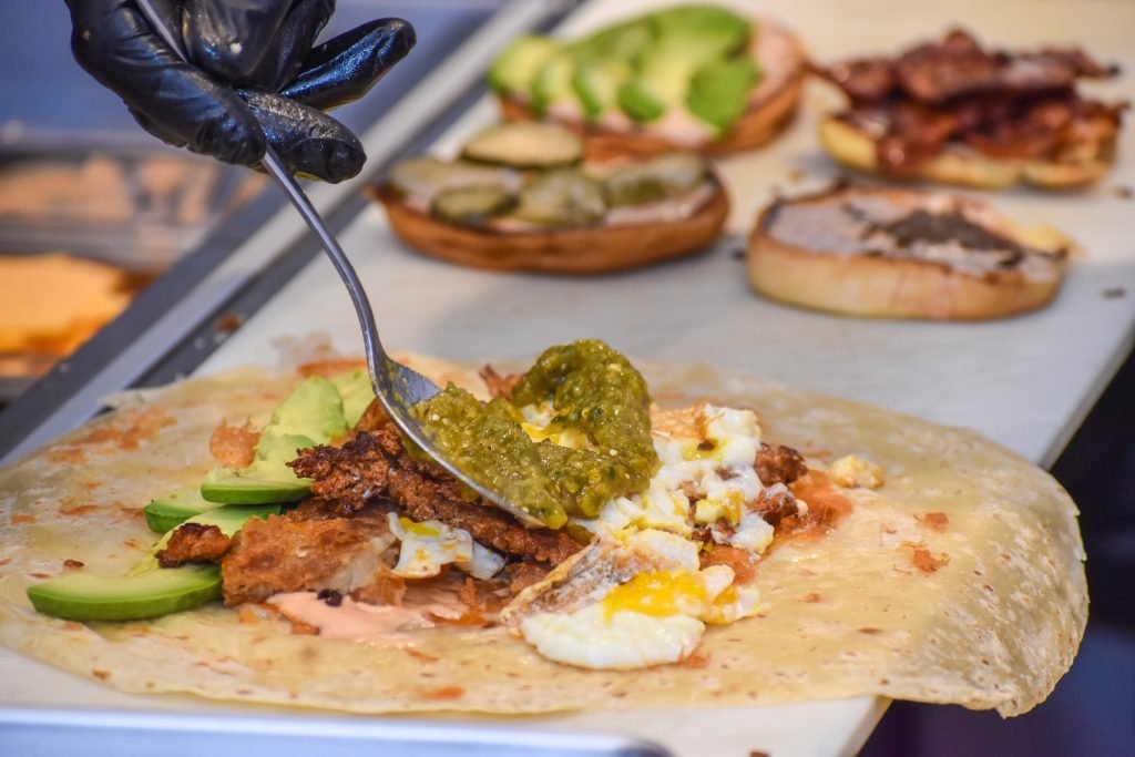 Chef Josh Haskal assembles a Breakfast Dream breakfast burrito. Photo by Brian Addison.