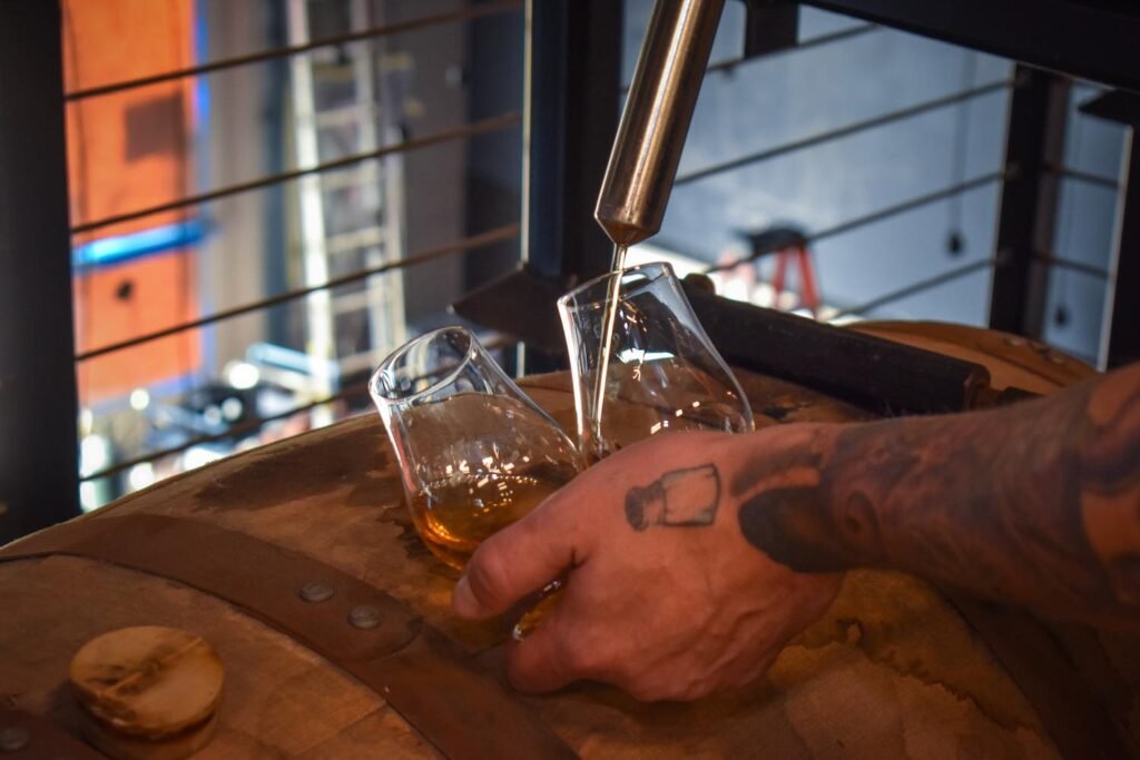 Breaking into a four-year-old aquavit Stecca distilled. Photo by Brian Addison.