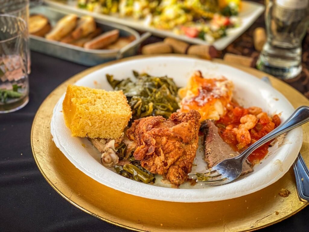 An array of offerings typical at the Black History Month farm dinner: corn bread, mac'n'cheese, fried chicken, brisket, étouffée... Photo by Brian Addison.